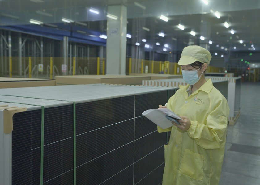 Masdar solar power project in Azerbaijan with rows of photovoltaic panels under clear skies, representing utility-scale clean energy development.